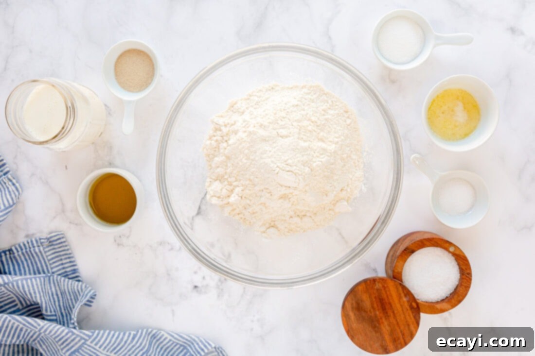 Irresistible Tear-and-Share Dinner Buns 4 Arrangement of fresh ingredients including flour, yeast, milk, and oil laid out for making Homemade Pull Apart Dinner Rolls.
