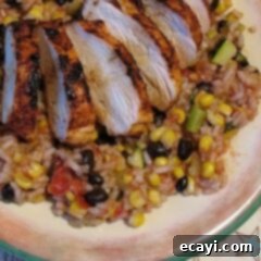 Chipotle Baja Grilled Chicken Platter 6 A perfectly plated serving of spicy grilled chicken with Baja black beans and rice, ready to enjoy.