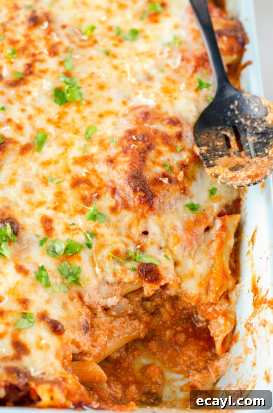 Ultimate Cheesy Ziti Bake 2 A large pan of freshly baked ziti, bubbling with sauce and melted cheese, ready to be served