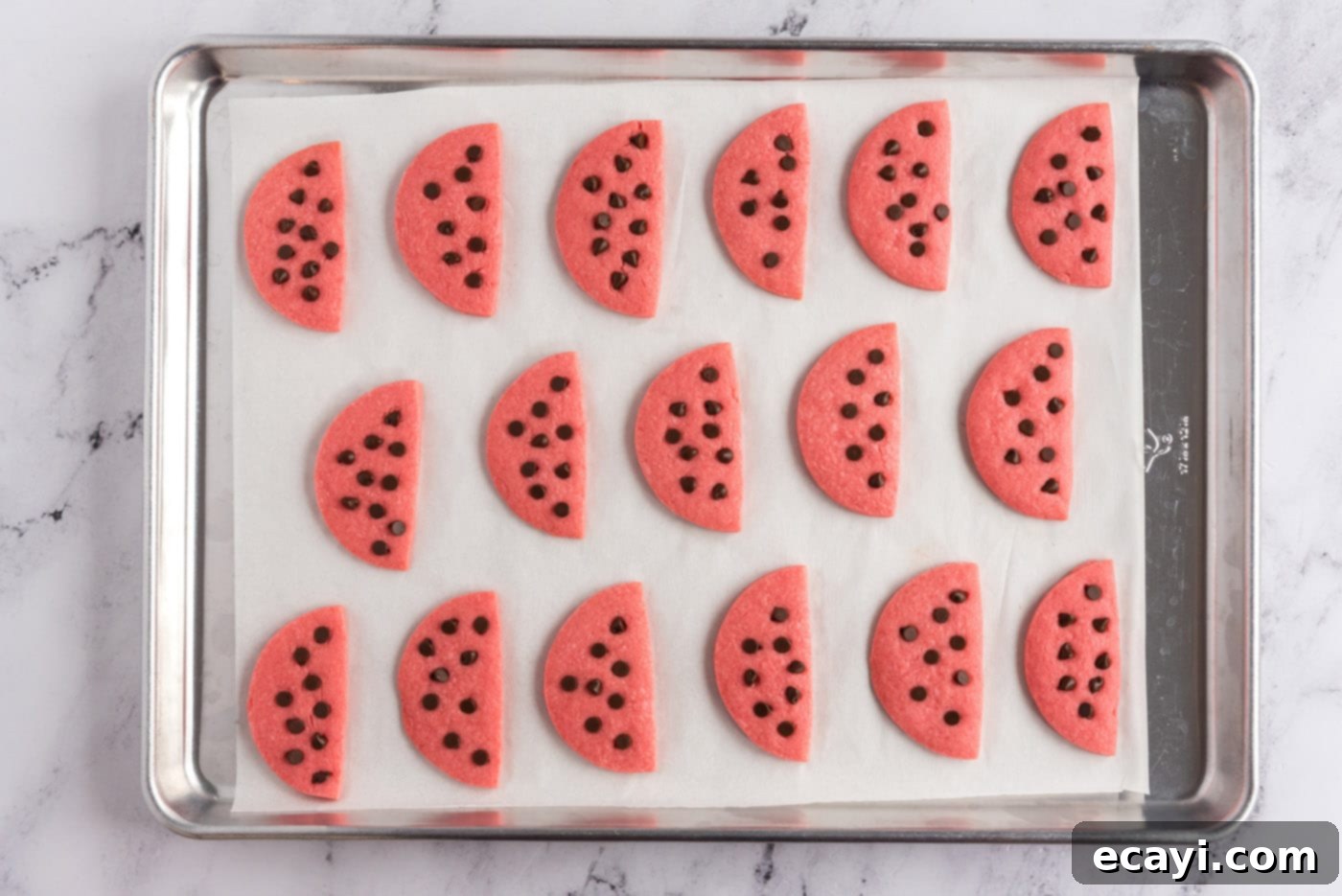 Melon Patch Morsels 12 watermelon cookies on a baking sheet
