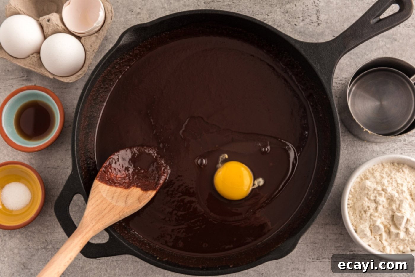Cast Iron Chocolate Dream 7 mixing egg into chocolate mixture in a skillet