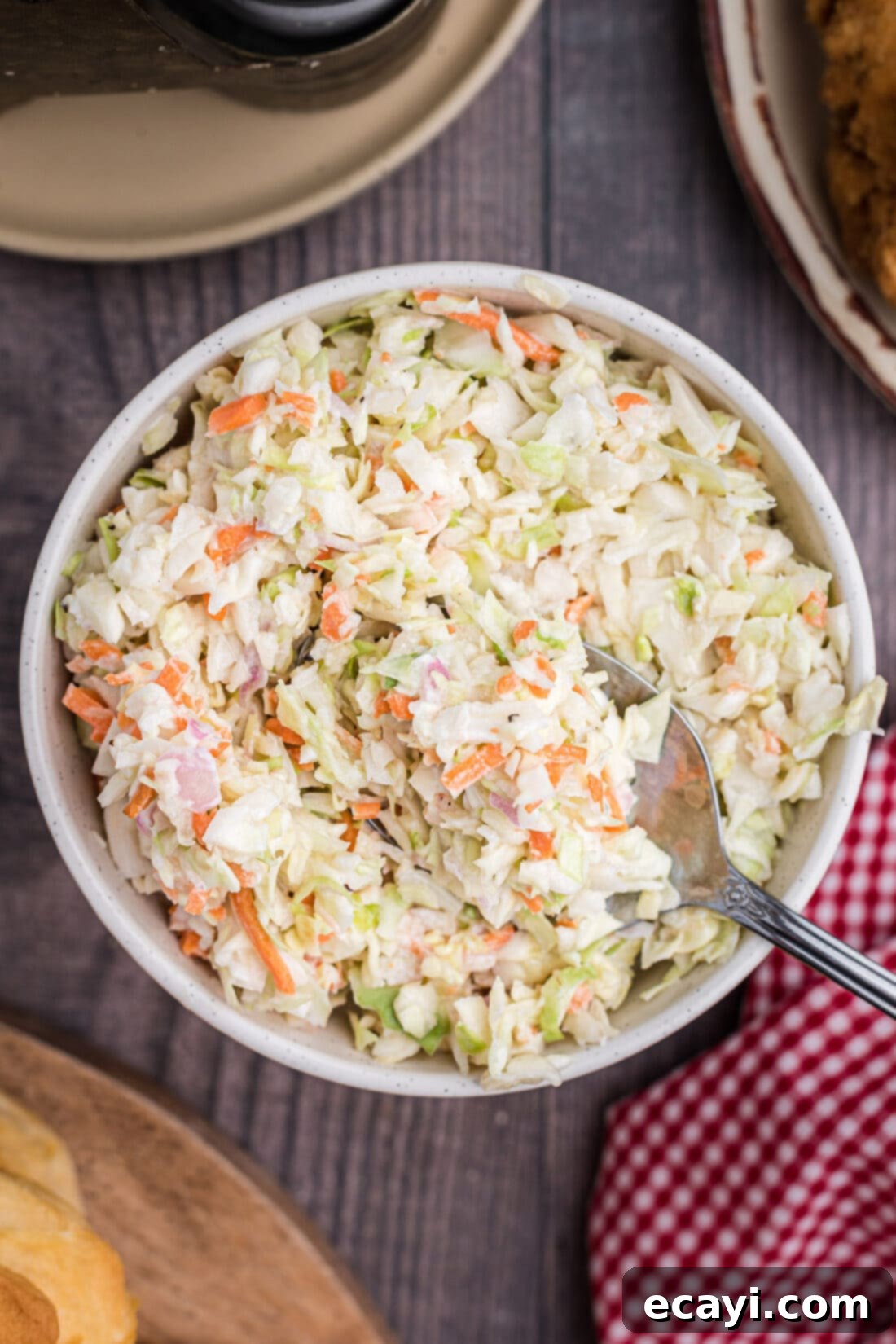 The Ultimate KFC Coleslaw Recipe 6 An inviting overhead shot of a large bowl of creamy, delicious homemade KFC coleslaw, garnished and ready for serving.