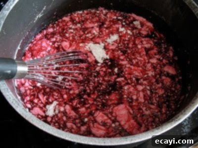 The Best Homemade Cherry Pie Filling 14 Clear Jel mixed with cherries and other ingredients in a pot