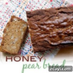 Golden Honey Pear Loaf 2 An overhead photo of a loaf of honey pear bread with a slice on the side.