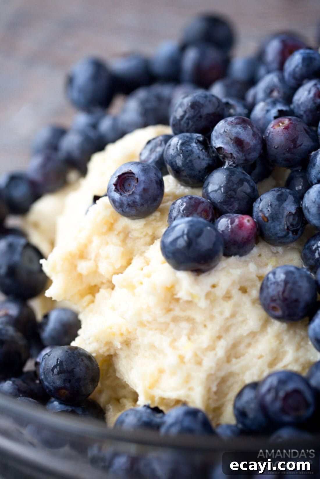 Folding Blueberries into Thick Cake Batter Fresh blueberries gently folded into the thick cake batter.