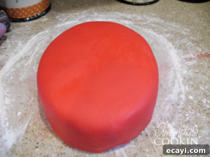 Spiderman Cake Magic: Homemade Marshmallow Fondant 6 A photo of a Spiderman-shaped cake perfectly covered in smooth, vibrant red homemade fondant.