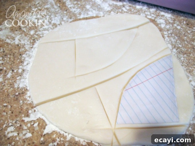 Spiderman Cake Magic: Homemade Marshmallow Fondant 8 A photo showing hand-drawn Spiderman eyes on paper, next to carefully cut white and black fondant pieces for the eyes.