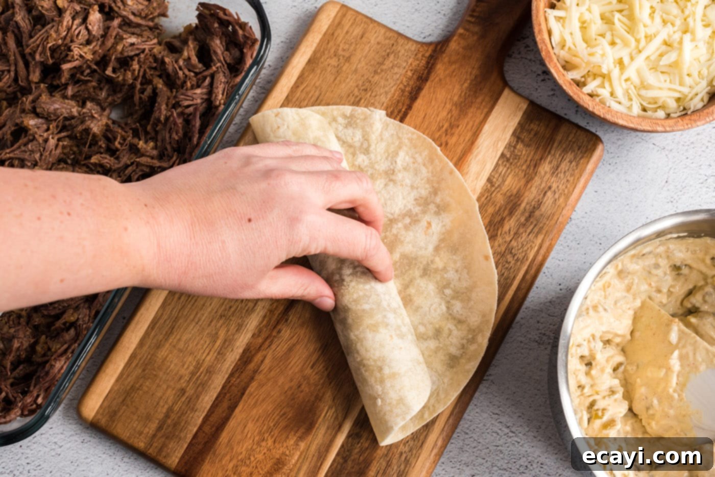 Classic Smothered Beef Enchiladas 17 Rolling up beef enchiladas with filling