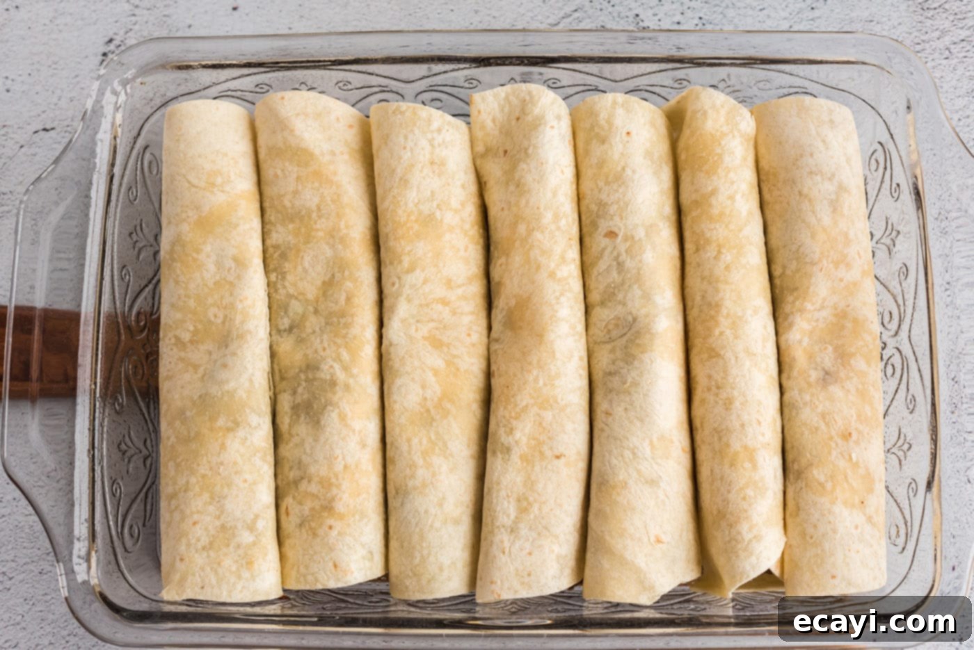 Classic Smothered Beef Enchiladas 18 Beef enchiladas arranged in a baking pan