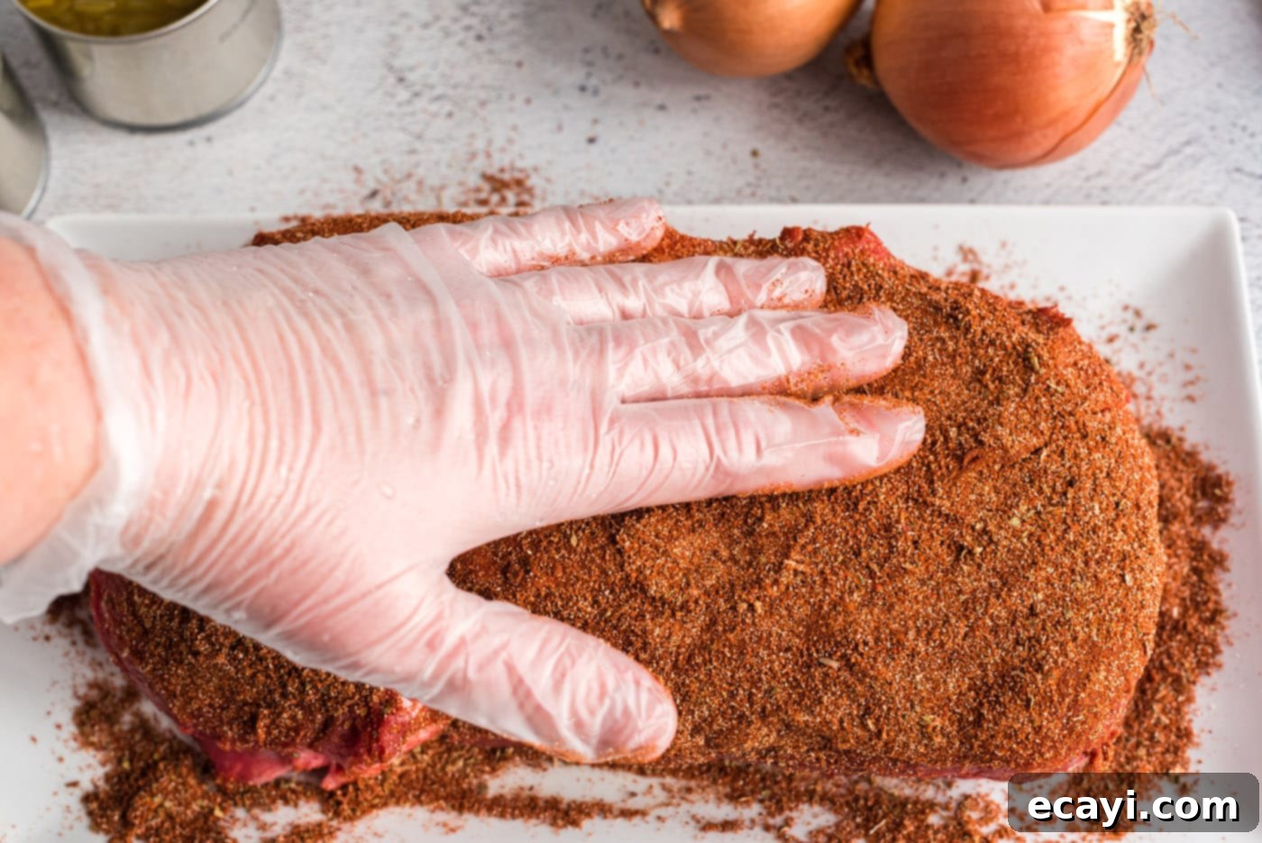 Classic Smothered Beef Enchiladas 5 Rubbing seasoning into a chuck roast for enchiladas
