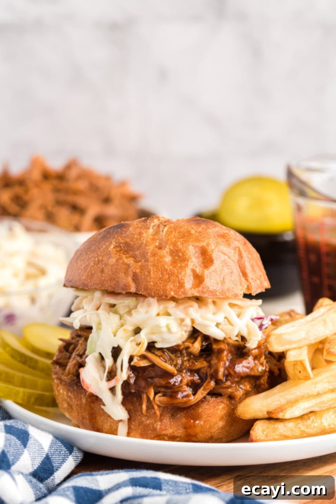Fall-Apart Tender Slow Cooker Pulled Pork 13 Slow Cooker Pulled Pork sandwich on plate with fries