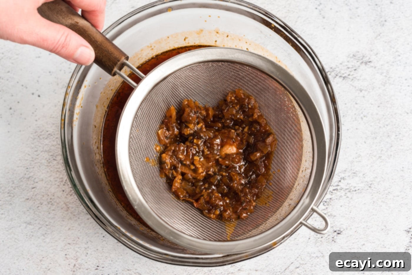 Fall-Apart Tender Slow Cooker Pulled Pork 9 straining pulled pork sauce