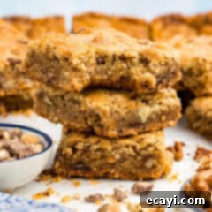 Golden Brown Butter Toffee Bars 15 Close up photo of a stack of Brown Butter Chocolate Toffee Blondies with a bite taken out of the top one