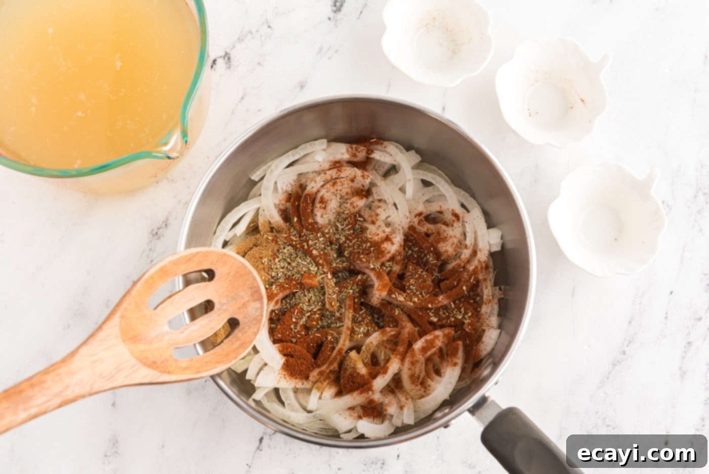 Zesty Chicken Chile Enchiladas 5 Sliced onion simmering with chicken broth, spices, and seasonings in a saucepan, reducing and concentrating flavors.