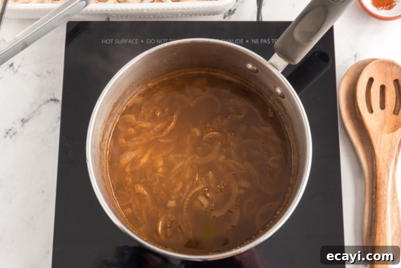 Zesty Chicken Chile Enchiladas 7 Reduced chicken broth mixture, rich with spices, ready for chicken infusion.