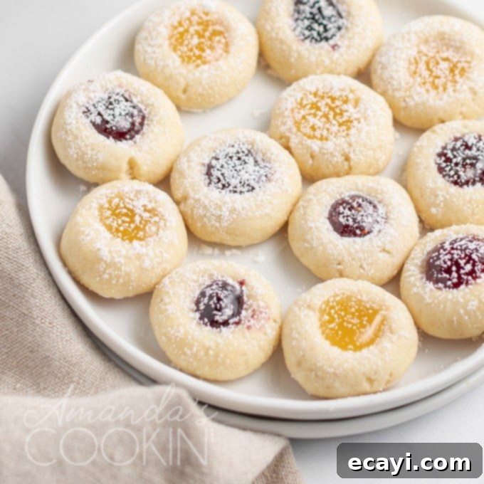 A delightful assortment of jam thumbprint cookies, showcasing their inviting appearance and delicious variety A charming plate adorned with a variety of thumbprint cookies, each filled with different colorful jams, ready to be enjoyed