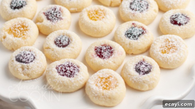 Delicious, soft, and firm thumbprint cookies with sweet jam filling, a universally loved dessert A mouth-watering close-up of finished thumbprint cookies, showcasing their perfect shape and glistening jam centers