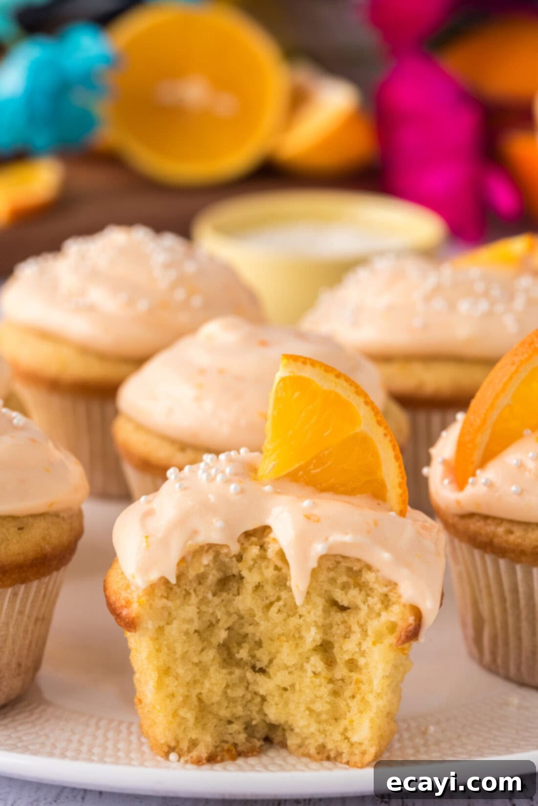 Orange Dream Swirl Cupcakes 2 Orange Creamsicle Cupcake with a bite taken out, showing the fluffy interior and creamy frosting.