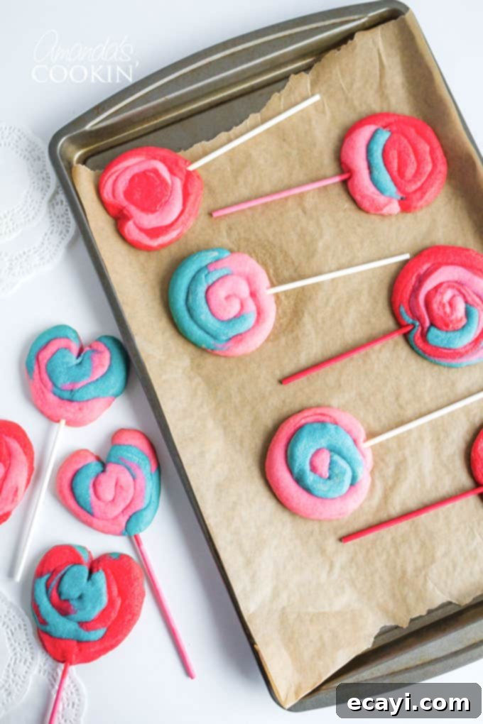 DIY Valentine Play Dough Cookie Pops 2 Colorful cookie pops on a baking pan, ready for the oven