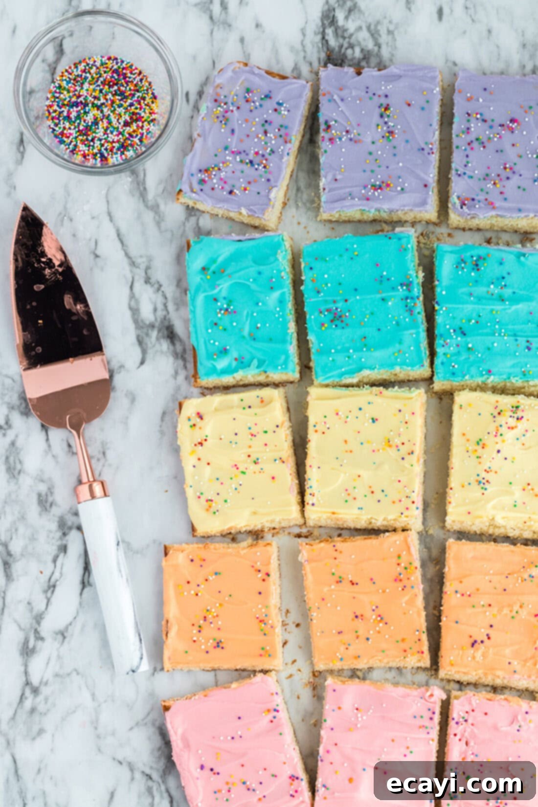 Irresistible Frosted Sugar Cookie Bars 3 Frosted Sugar Cookie Bars resting on a table, showcasing their vibrant colors and soft frosting.