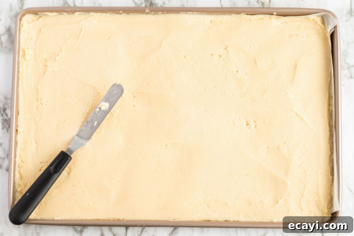 Irresistible Frosted Sugar Cookie Bars 8 Raw sugar cookie dough pressed evenly into a large jelly roll pan, ready for baking.