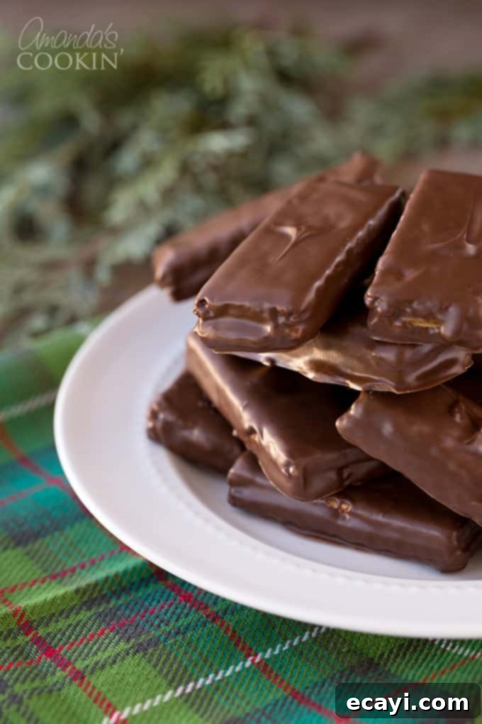 Peanut butter and chocolate lovers and going to go crazy for these super easy to make homemade candy bars. Great for snack or gift giving! #chocolate #candy #desserts #homemade #homemadecandy #candybars #nobake #peanutbutter #valentinesday #peanutbutterdesserts Homemade Candy Bars with peanut butter and chocolate, ready to be enjoyed