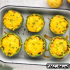 Chili Cornbread Stuffed Peppers 14 Overhead photo of Chili and Cornbread Stuffed Peppers in a baking pan, golden and bubbly.