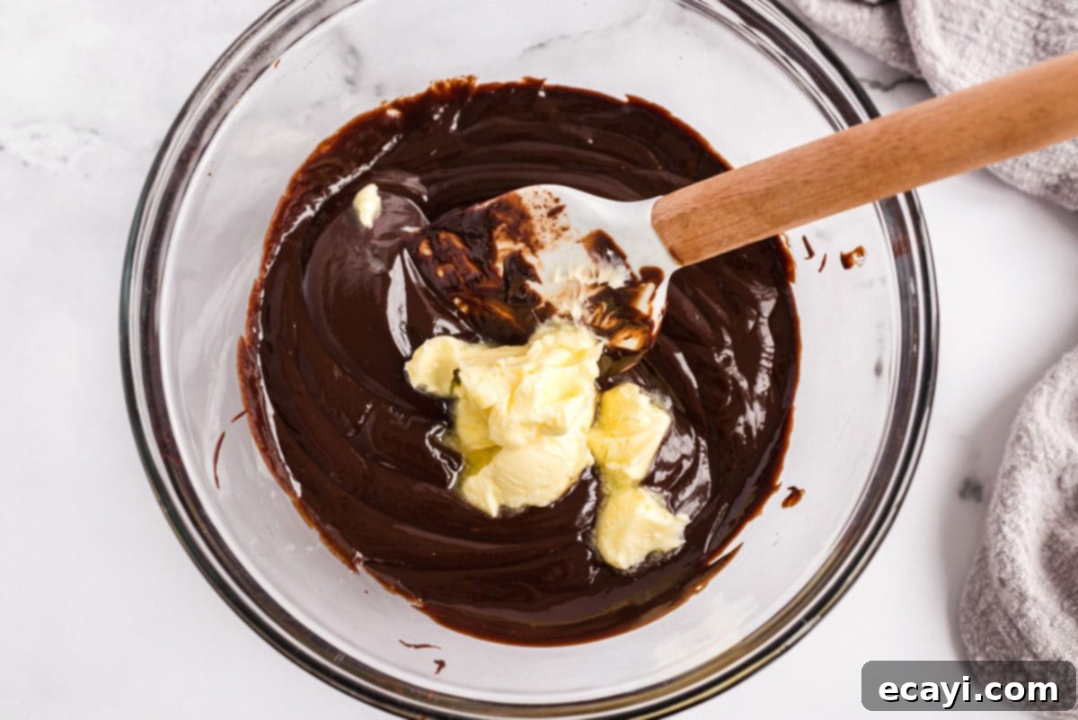 Preparing Chocolate Ganache Ingredients for chocolate ganache: hot cream poured over chocolate and butter cubes in a bowl