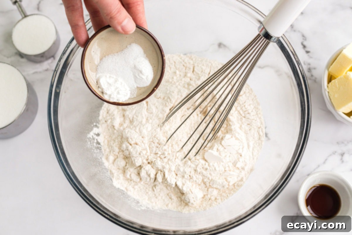 Whisking Dry Ingredients for Cupcakes Whisking together flour, baking soda, baking powder, and salt in a large bowl
