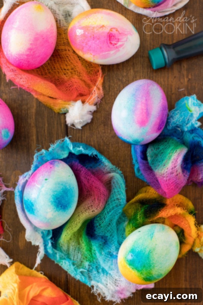 Learn how to make vibrant tie-dye patterns on Easter eggs using cheesecloth. Hard-boiled eggs wrapped in cheesecloth with food coloring drops
