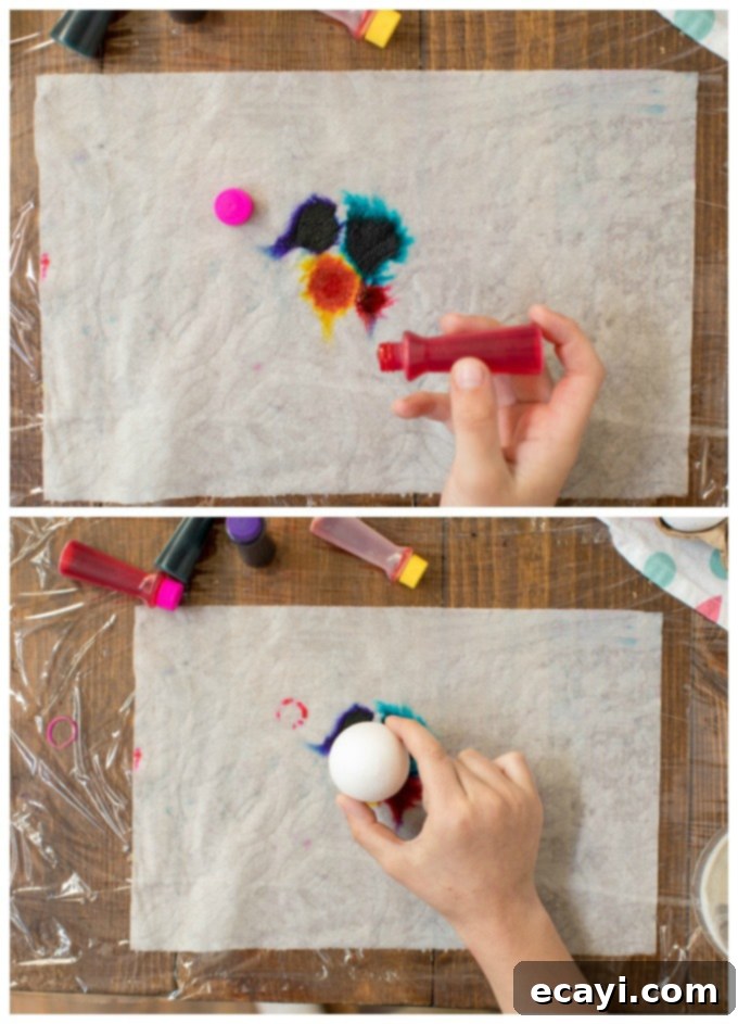 How to apply food coloring to a damp paper towel for tie-dye eggs. Applying drops of liquid food coloring onto a damp paper towel