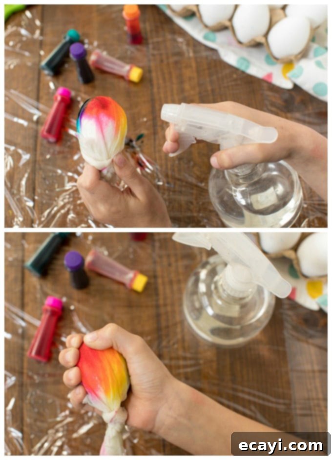 Activating food coloring on paper towel-wrapped eggs with a spray bottle. Spraying a paper towel-wrapped egg with water to activate tie-dye colors