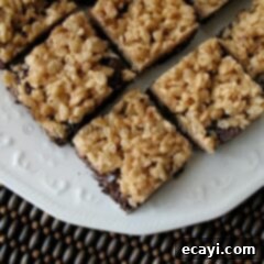 Ultimate Chewy Cookie Crunch Bars 2 A close up photo of chewy cookie crunch bars on a white plate.