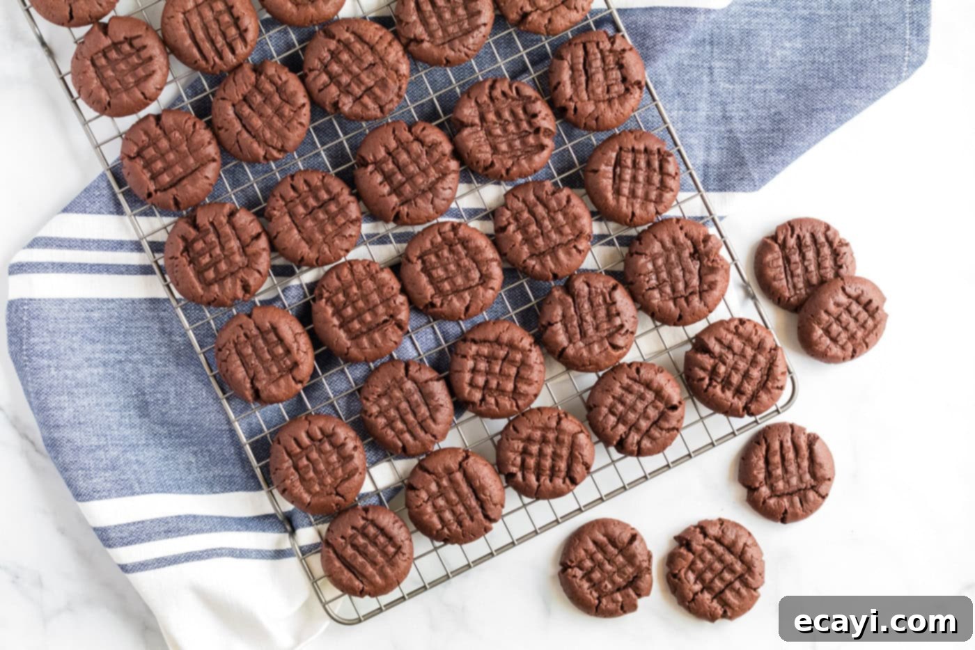 The Ultimate Chocolate Peanut Butter Cookies 10 Warm chocolate peanut butter cookies delicately resting on a wire cooling rack to achieve their perfect texture.