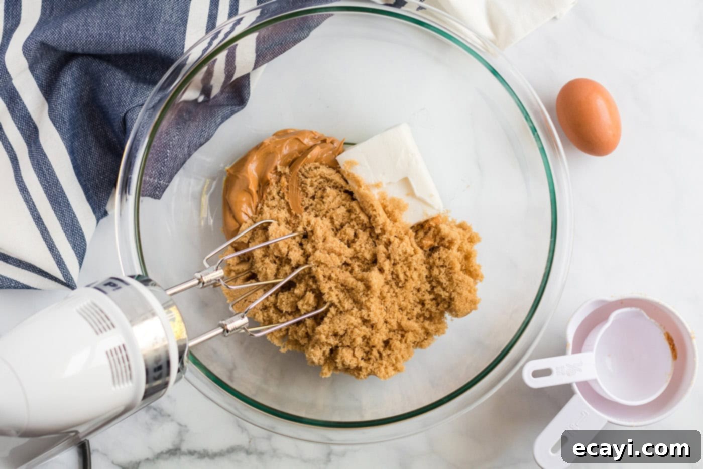 The Ultimate Chocolate Peanut Butter Cookies 4 Shortening, peanut butter, brown sugar, milk, and vanilla being creamed together in a large mixing bowl.