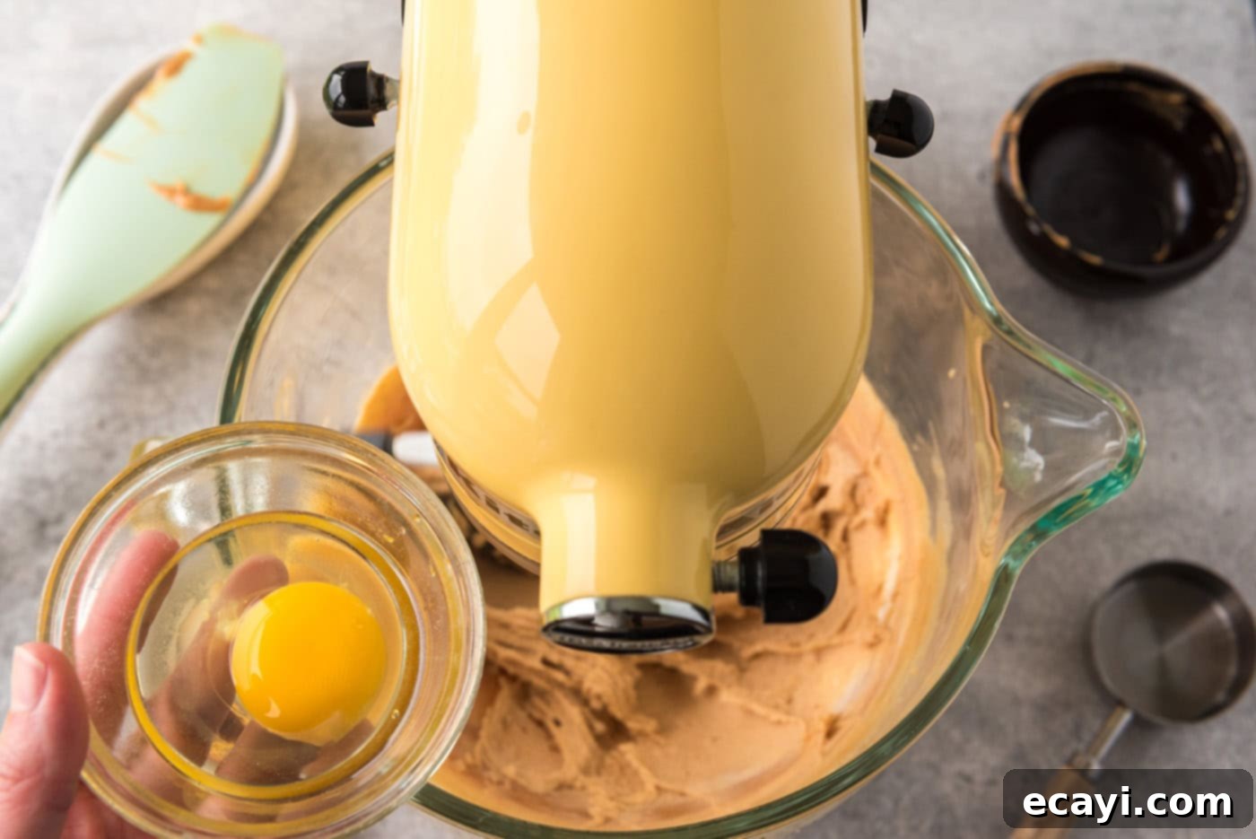 Deep Dish Peanut Butter Brownie 5 Adding eggs to a mixer bowl with peanut butter and cream cheese mixture