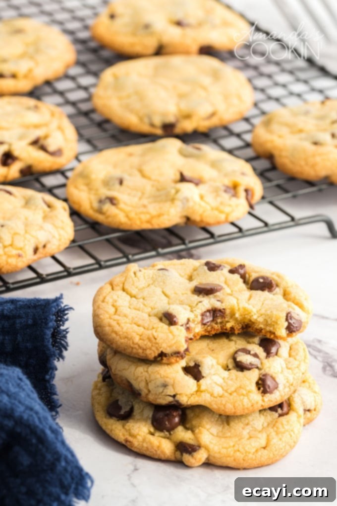 Indulge in the soft, chewy perfection of these Chocolate Chip Pudding Cookies, a truly unforgettable homemade treat. Chocolate Chip Pudding Cookies displayed beautifully on a cooling rack, glistening with melted chocolate