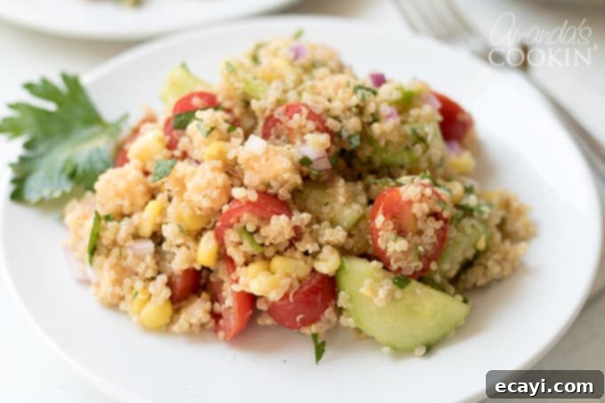 Garden Fresh Summer Quinoa Delight 10 A large serving bowl filled with the fully prepared and chilled Summer Vegetable Quinoa Salad, ready to be enjoyed.