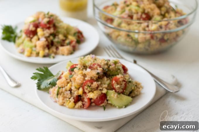 Summer Vegetable Quinoa Salad Summer Vegetable Quinoa Salad presented beautifully on a white platter, garnished and ready to serve.