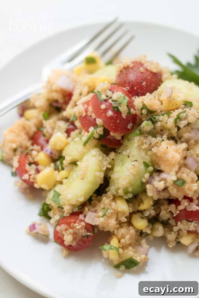 Garden Fresh Summer Quinoa Delight 2 Close-up view of a bowl of Summer Vegetable Quinoa Salad, highlighting the crisp textures and varied colors of the ingredients.