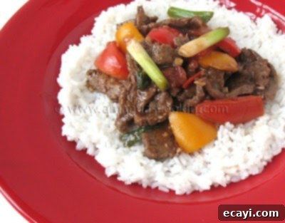 Zesty Beef, Tomato, and Bell Pepper Stir-Fry 2 Delicious Beef Stir Fry with Tomatoes and Peppers, ready to serve over rice
