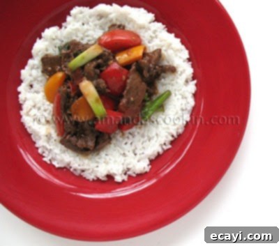 Zesty Beef, Tomato, and Bell Pepper Stir-Fry 3 Hearty Beef Stir Fry with Tomatoes and Peppers served over fluffy rice, perfect for dinner