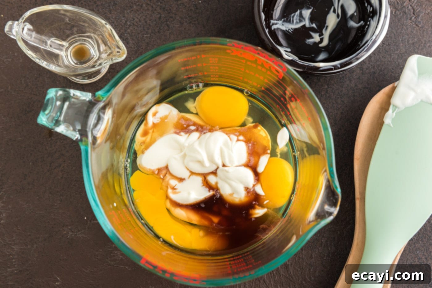 Decadent Chocolate Fudge Delight 8 eggs, sour cream, and vanilla in a bowl
