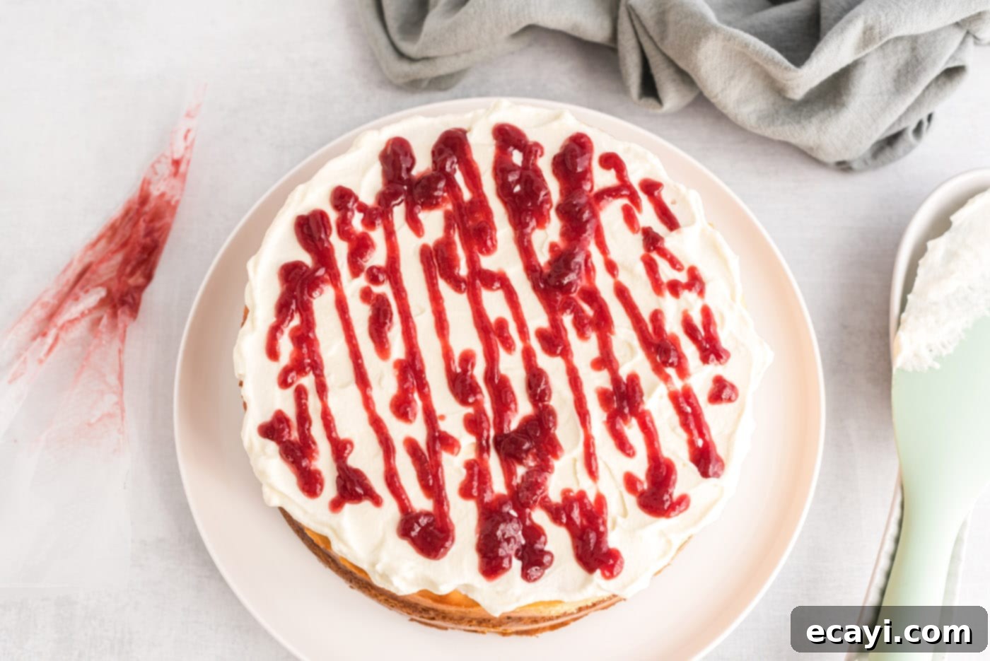 Regal Trifle Cheesecake 14 A delicate raspberry preserve drizzle decorating the whipped cream topping of an English Trifle Cheesecake.