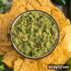Vibrant Tomatillo Avocado Onion Salsa 10 Bowl of Tomatillo Onion Avocado Salsa surrounded by tortilla chips, ready for serving.