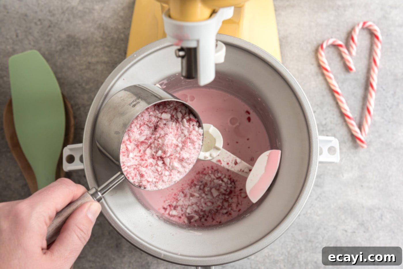 Cool Peppermint Bliss 8 pouring crushed peppermint candies into ice cream maker
