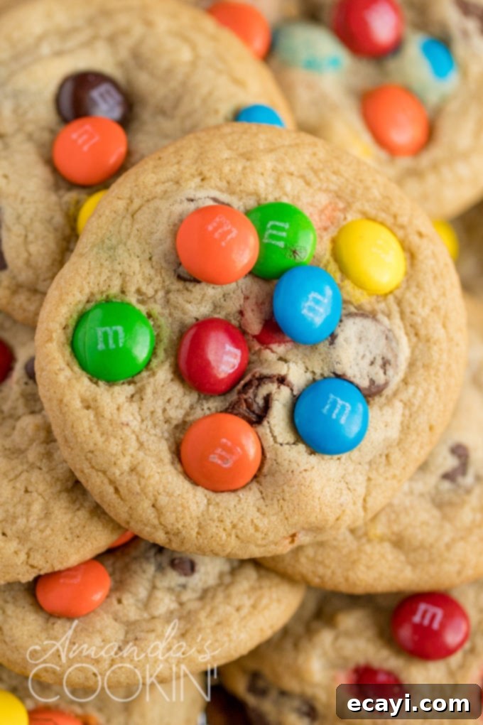 A delicious close-up of a homemade Chocolate Chip M&M Cookie, perfect for a treat. Close-up of a perfectly baked, chewy chocolate chip M&M cookie, showing melted chocolate chips and vibrant M&M candies on top.