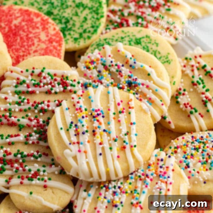 The Ultimate Christmas Cookie Collection: 12 Days 12 Beautifully decorated Christmas sugar cookies on a wooden board