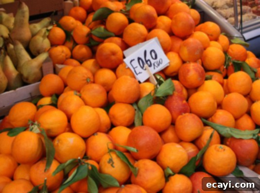 Oranges at the market in Catania, Sicily Vibrant, fresh oranges piled high at a bustling market stall in Catania, Sicily