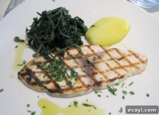 Pesce spada  - grilled swordfish with wilted greens and super-flavorful olive oil Pesce spada - expertly grilled swordfish accompanied by wilted greens and a drizzle of rich, flavorful olive oil